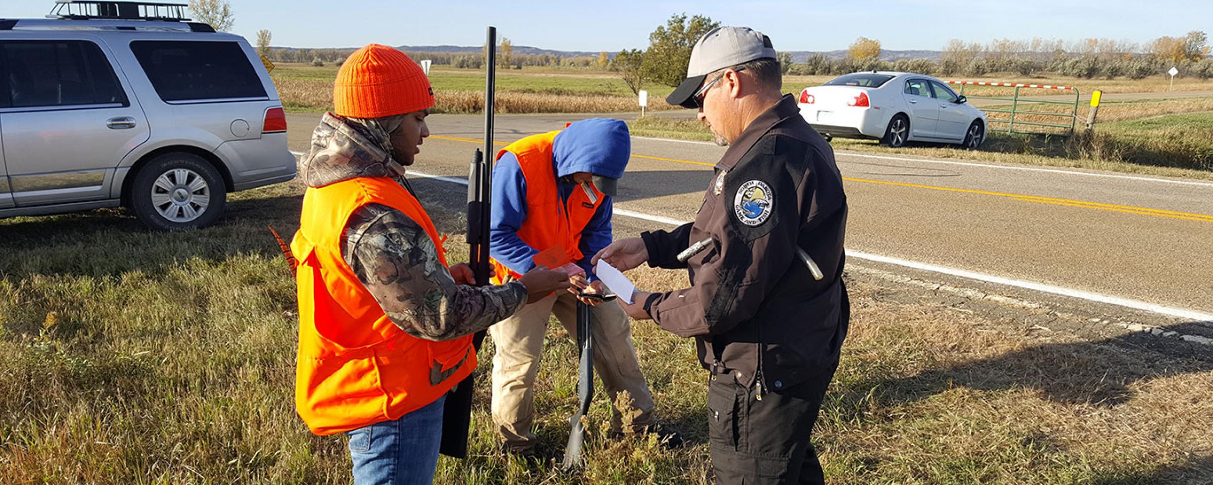 Warden checking licenses in the field