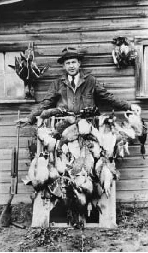 1929 man with harvested birds