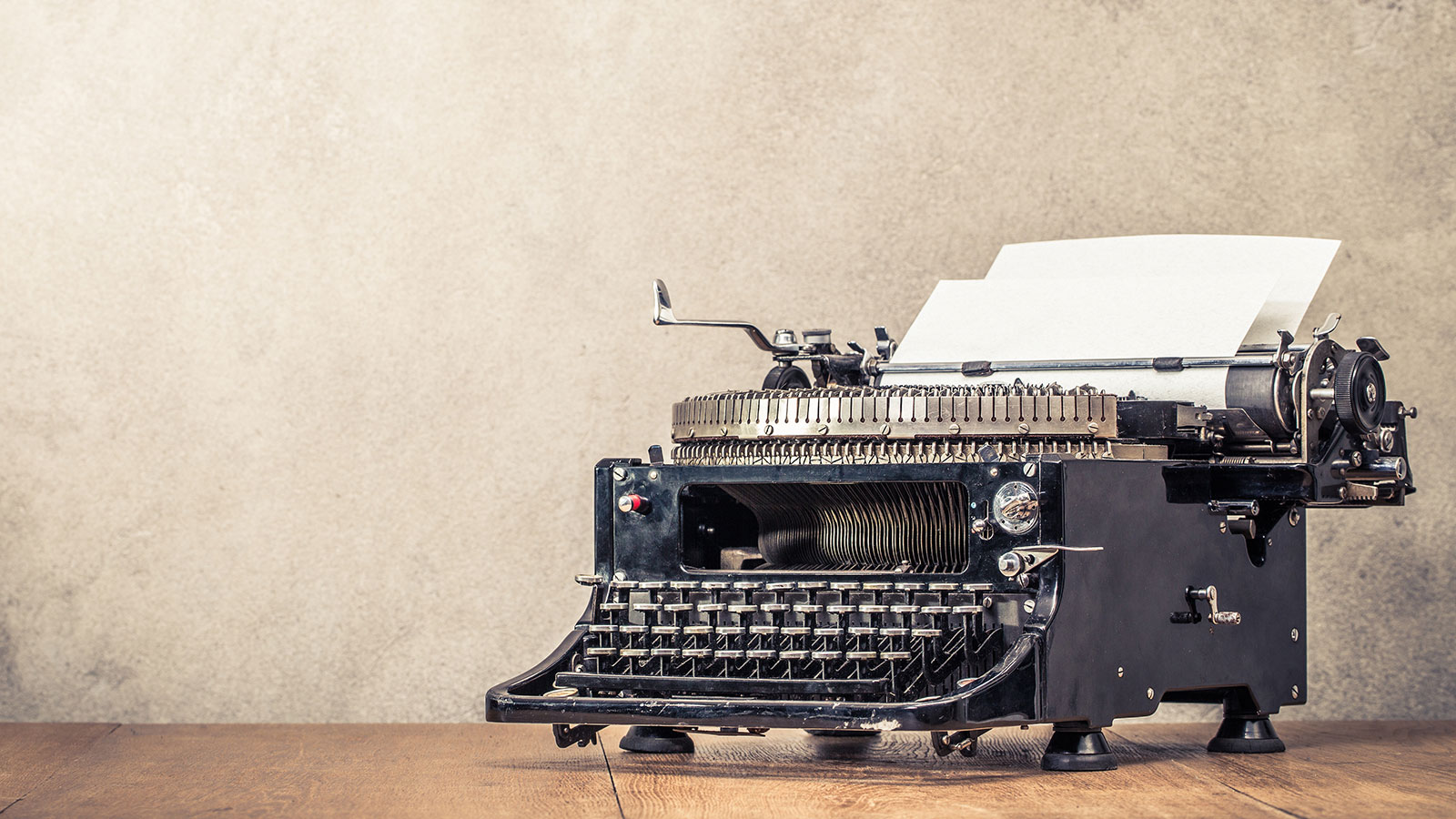 Vintage typewriter on wood background