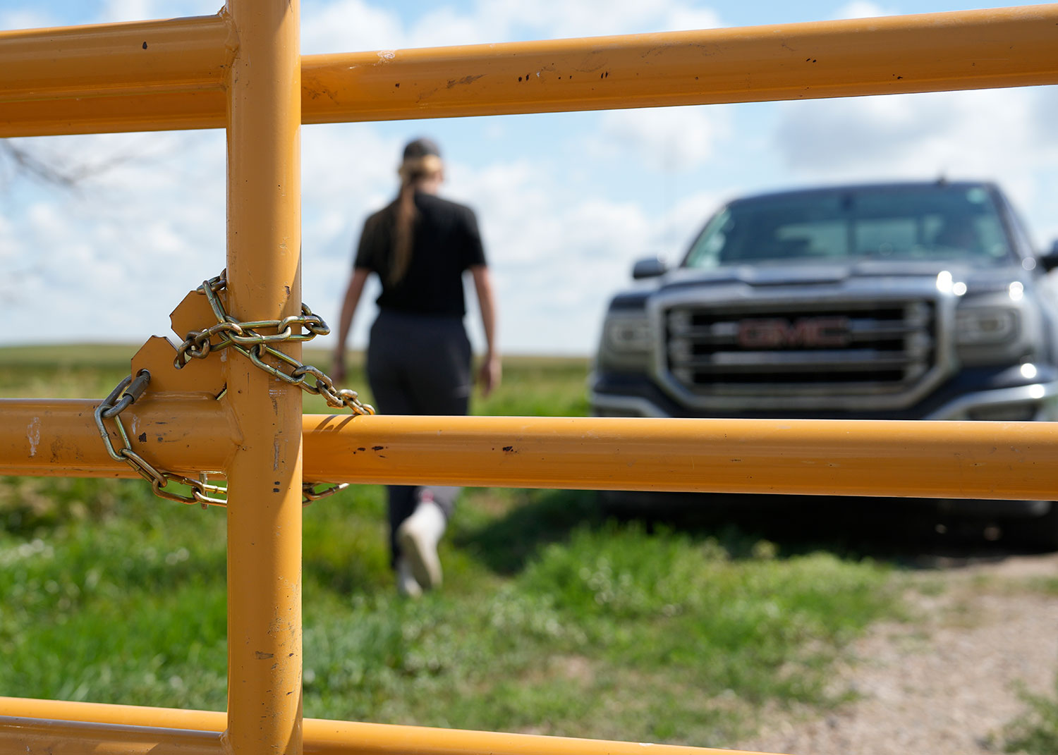 Person walking away from closed gate