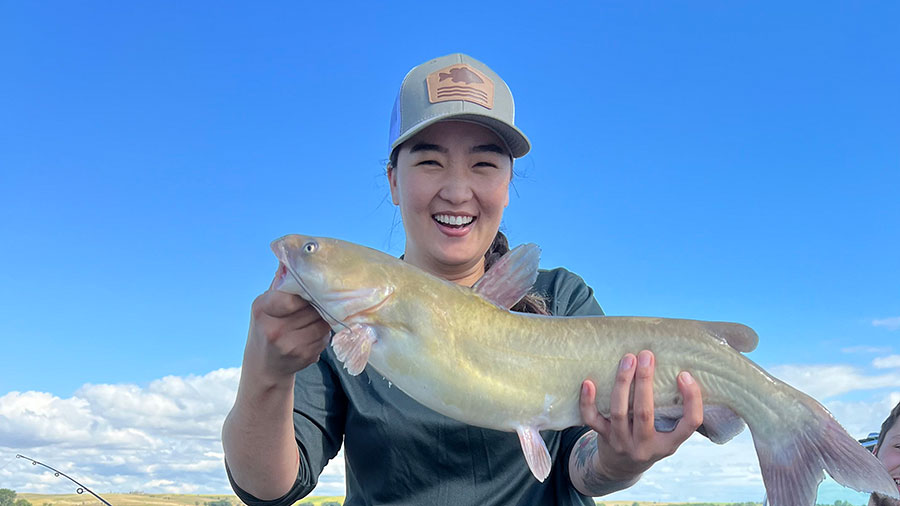 Woman holding fish she caught