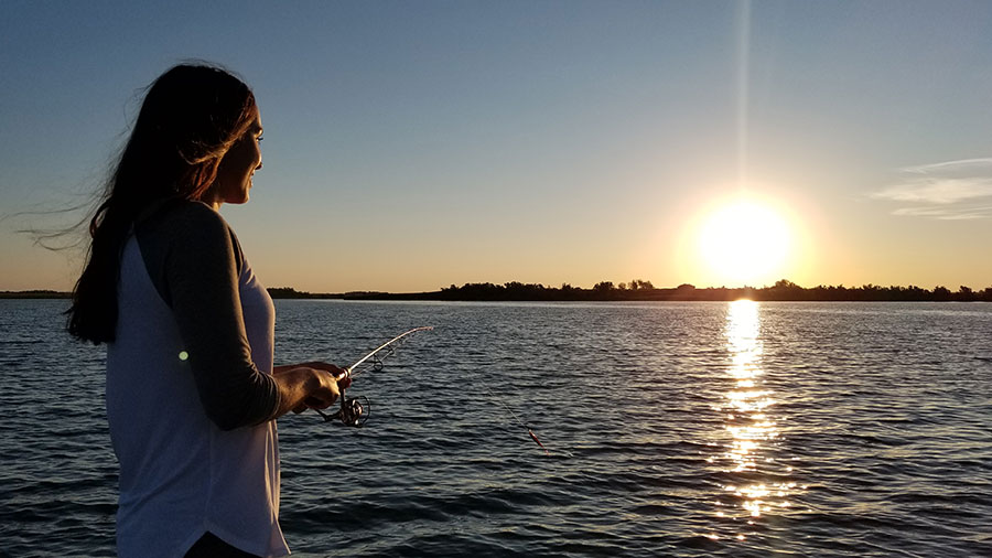 Woman fishing on lake