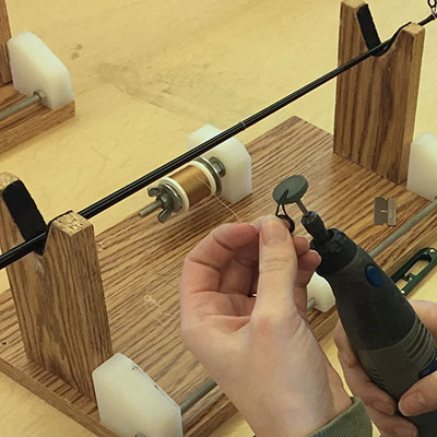 Person working on a fishing rod