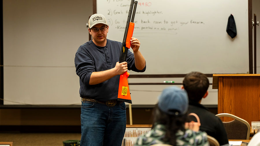 Volunteer teaching a hunter education class