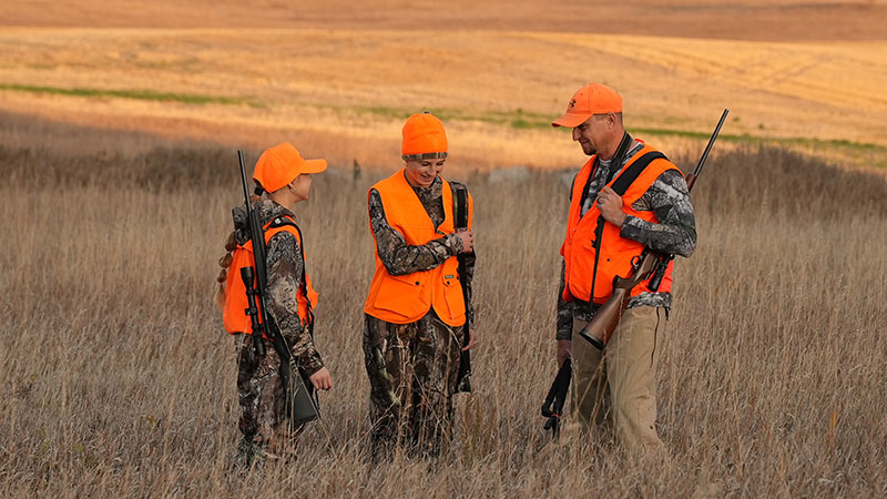 Father and daughters out deer hunting