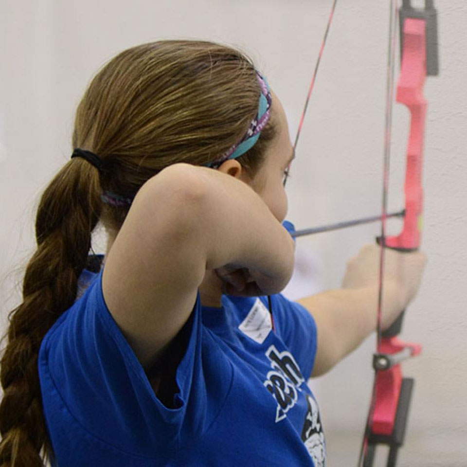 Girl shooting bow and arrow