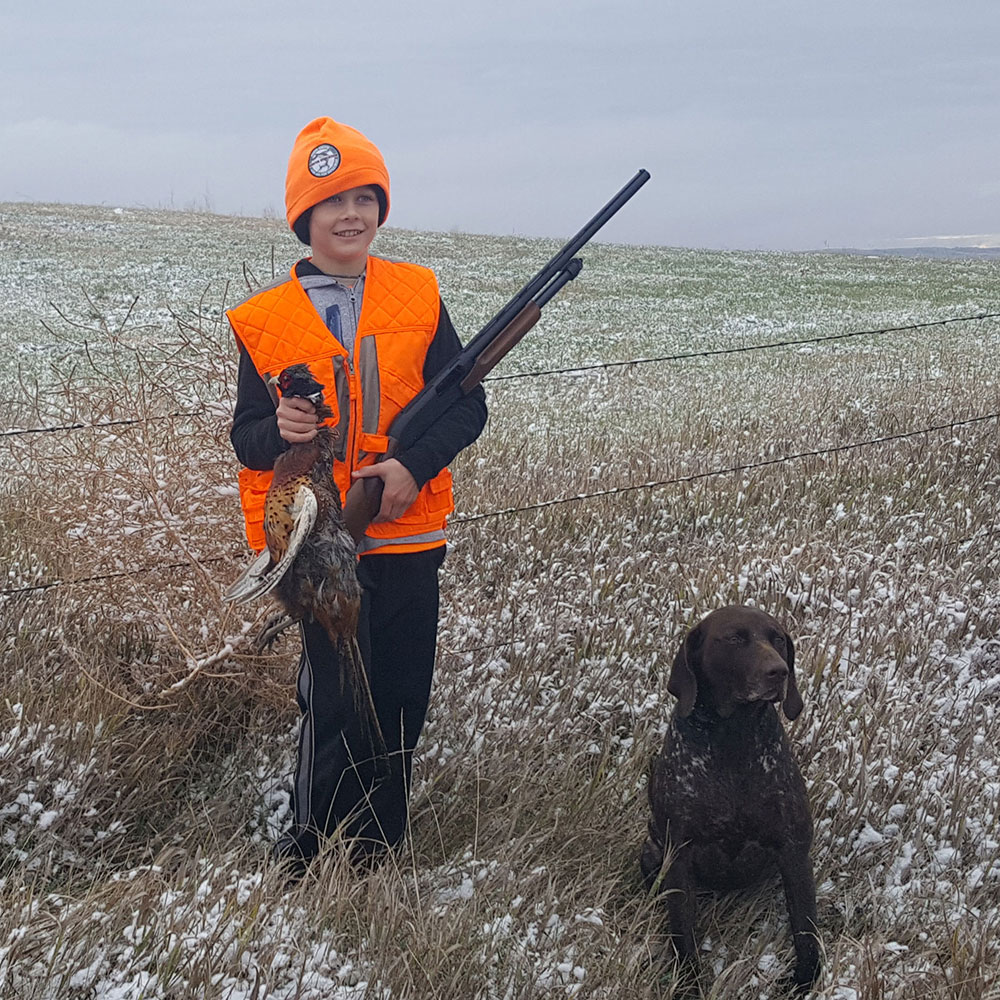 Youth with harvested pheasant