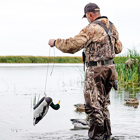 Hunter putting duck decoys into the water