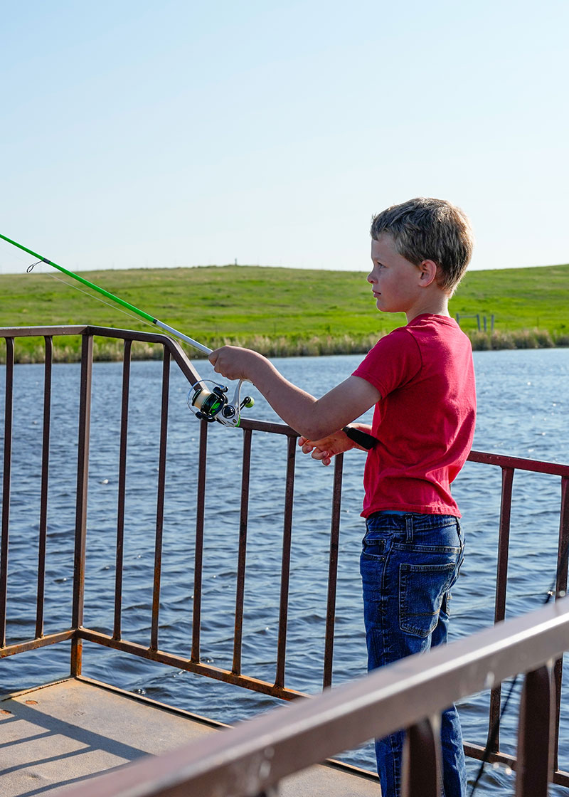 Boy fishing from dock