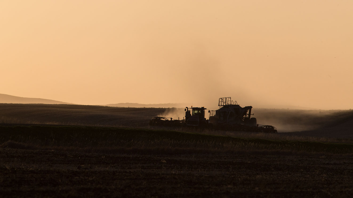 Farm equipment working in field