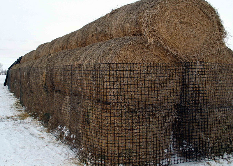 Hay bails stacked with fencing surrounding them