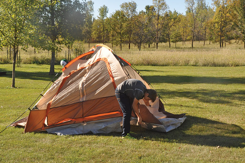 Youth setting up tent