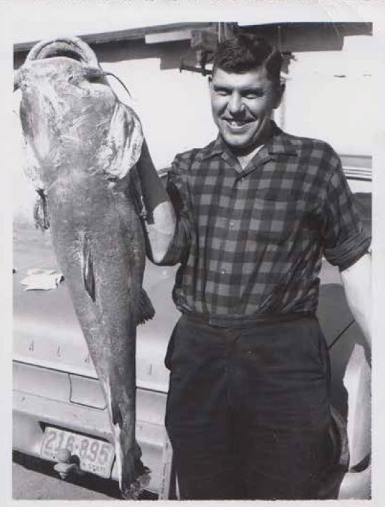 Man holding catfish