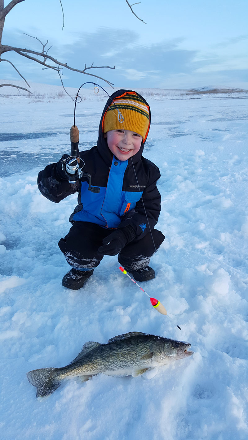 Young angler with fish