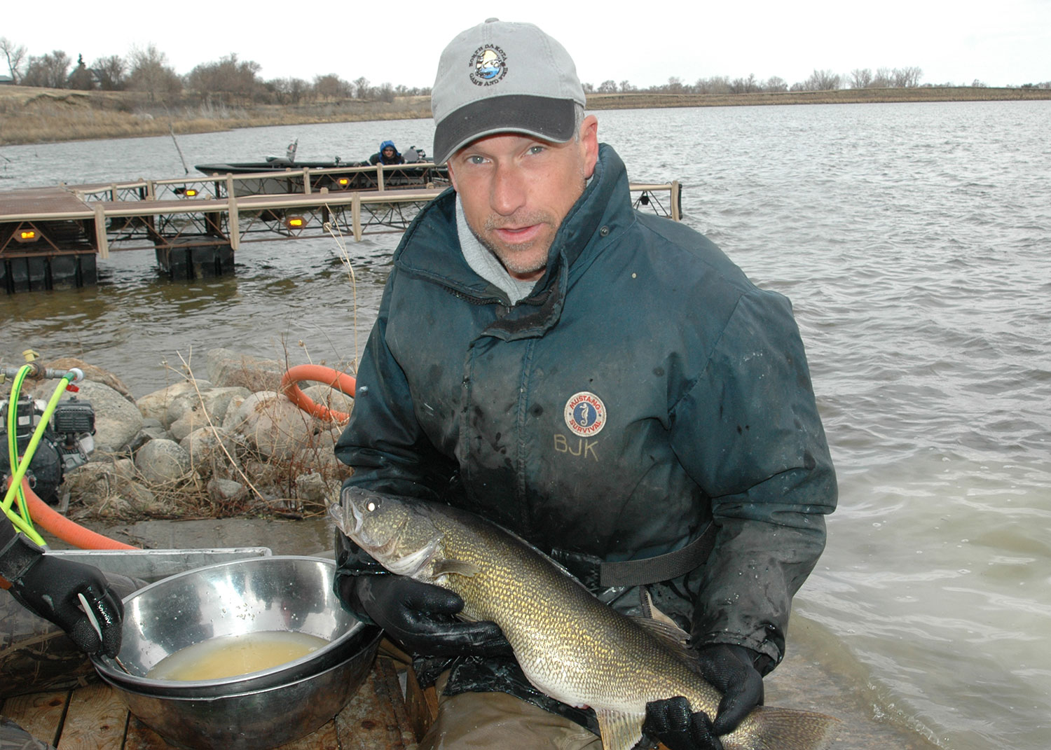 Female walleye held by fisheries biologist