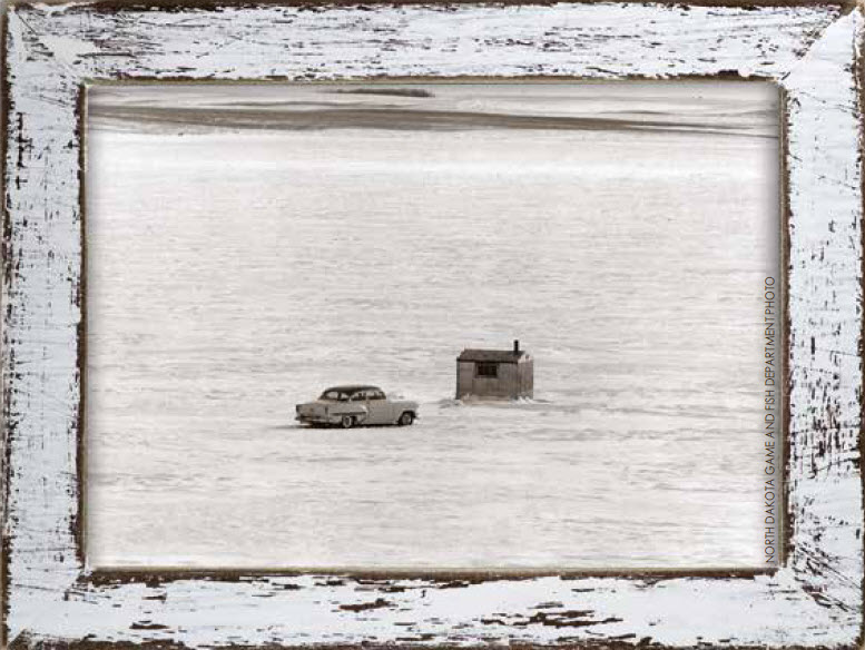 Old icehouse and car on lake