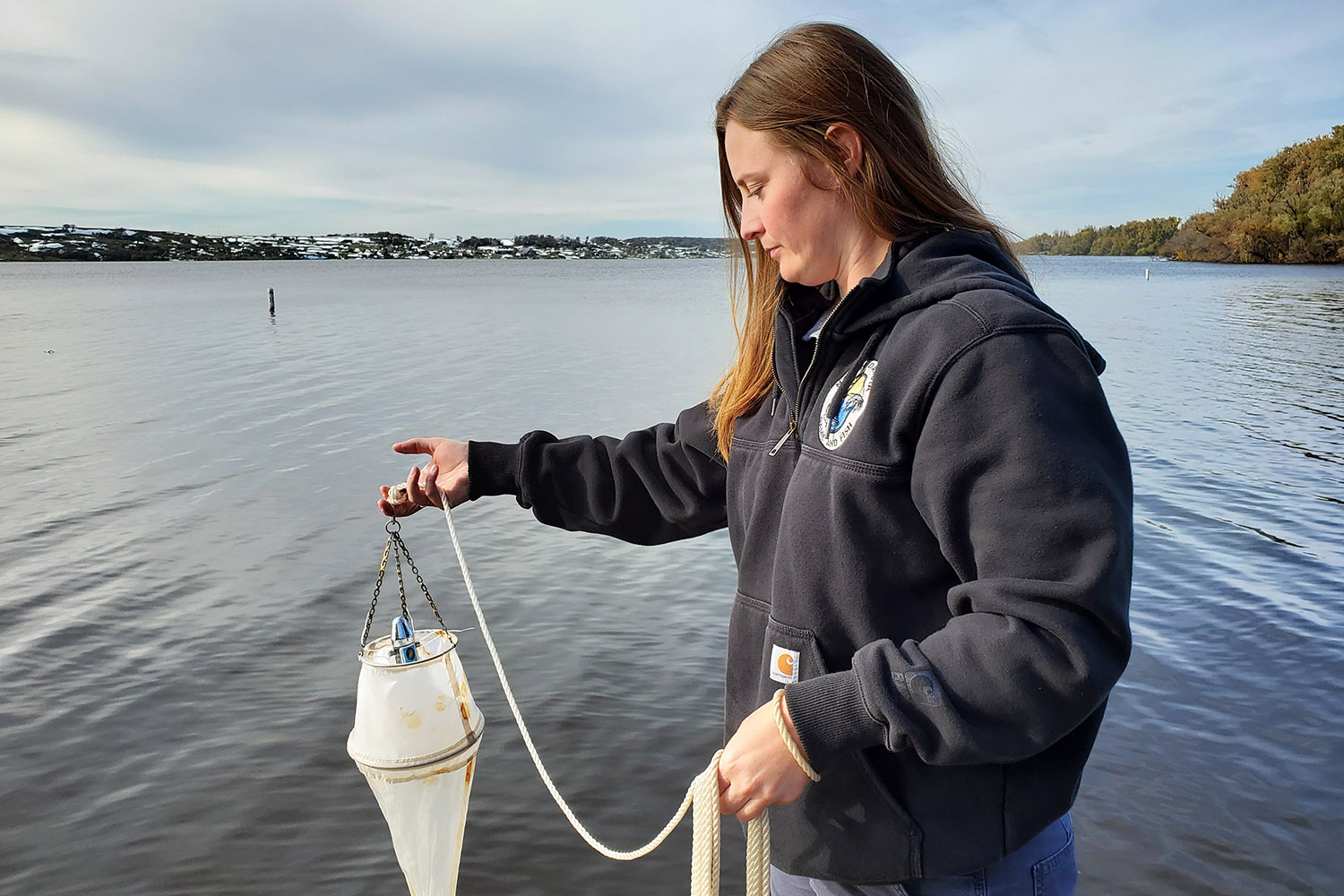 Staff testing water sample for zebra mussels
