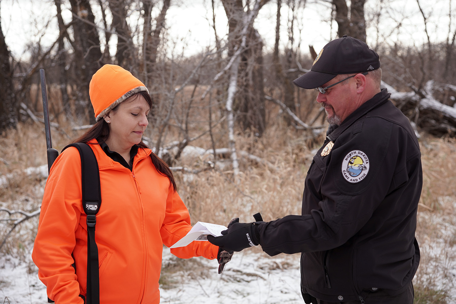 Warden checking hunter's license