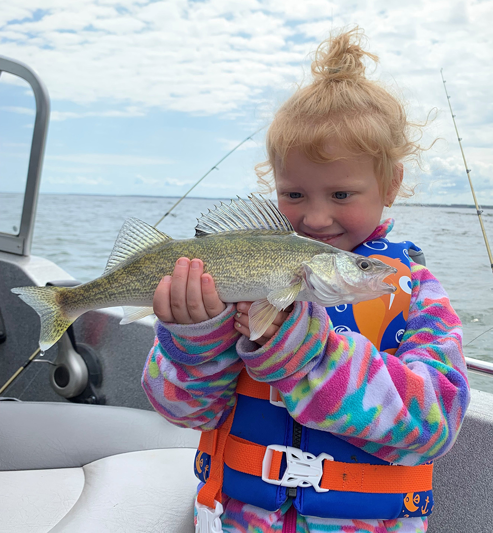 Child holding a walleye she caught