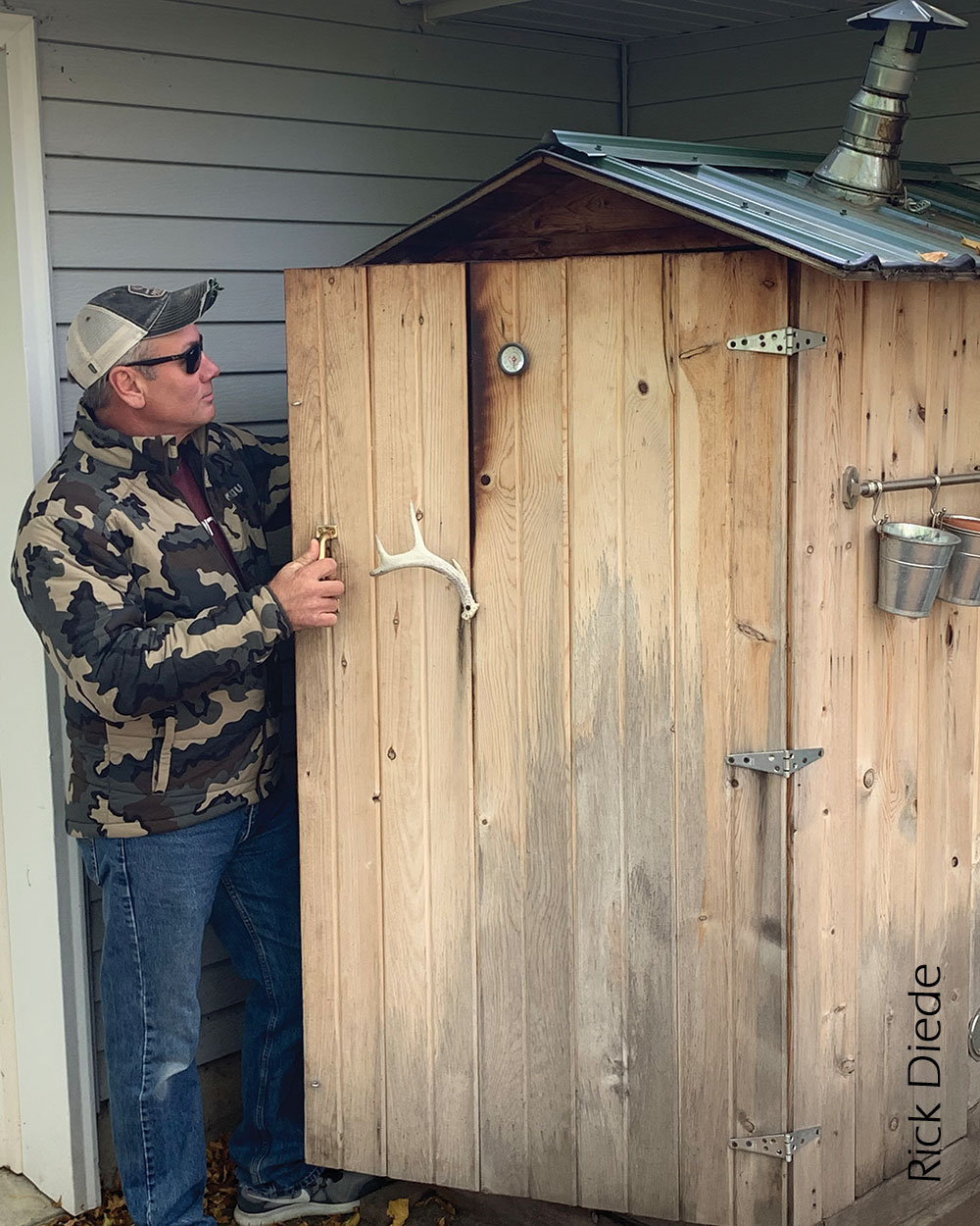 Man looking into smokehouse