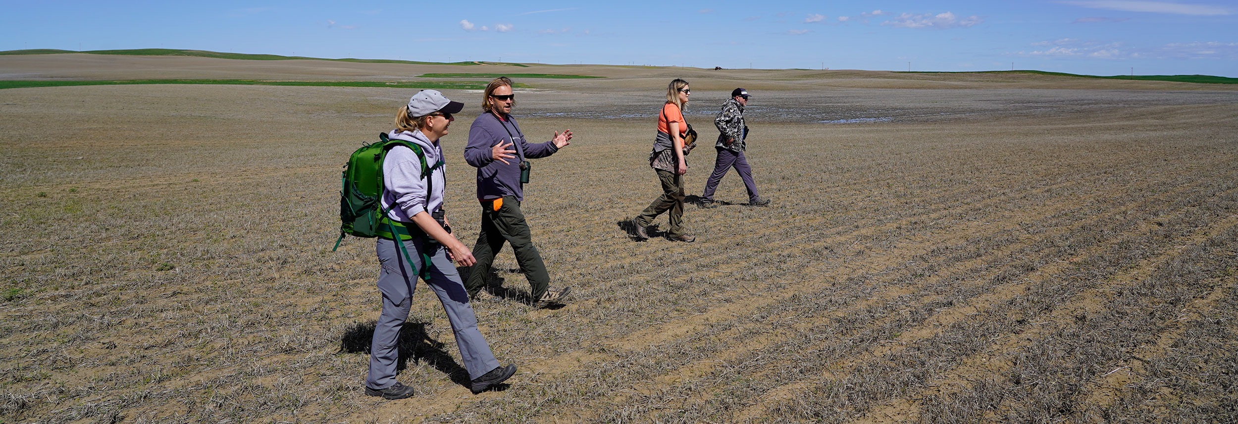Researchers walking in a field