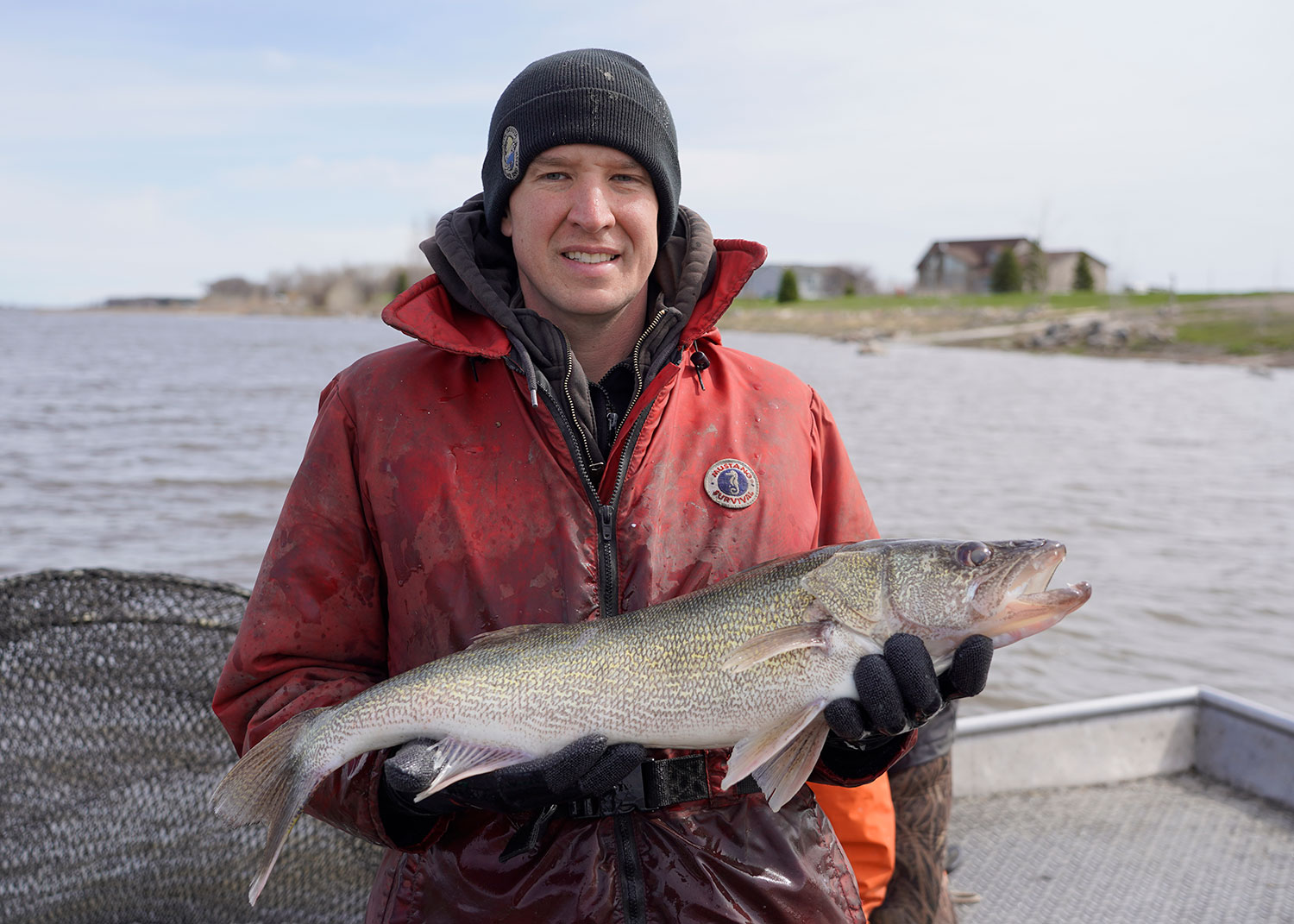 Biologist Todd Caspers holding walleye