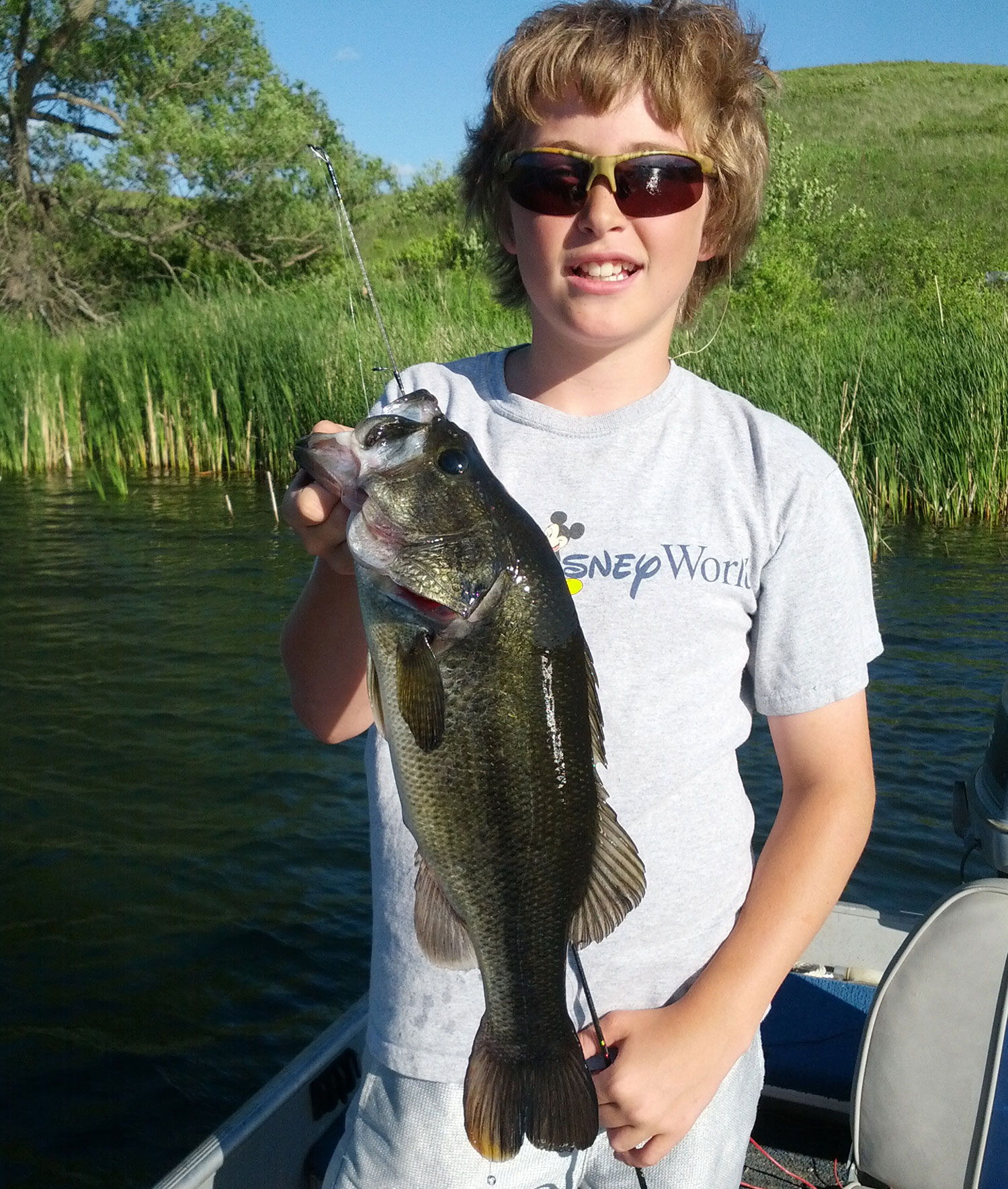 Kid holding up largemouth bass