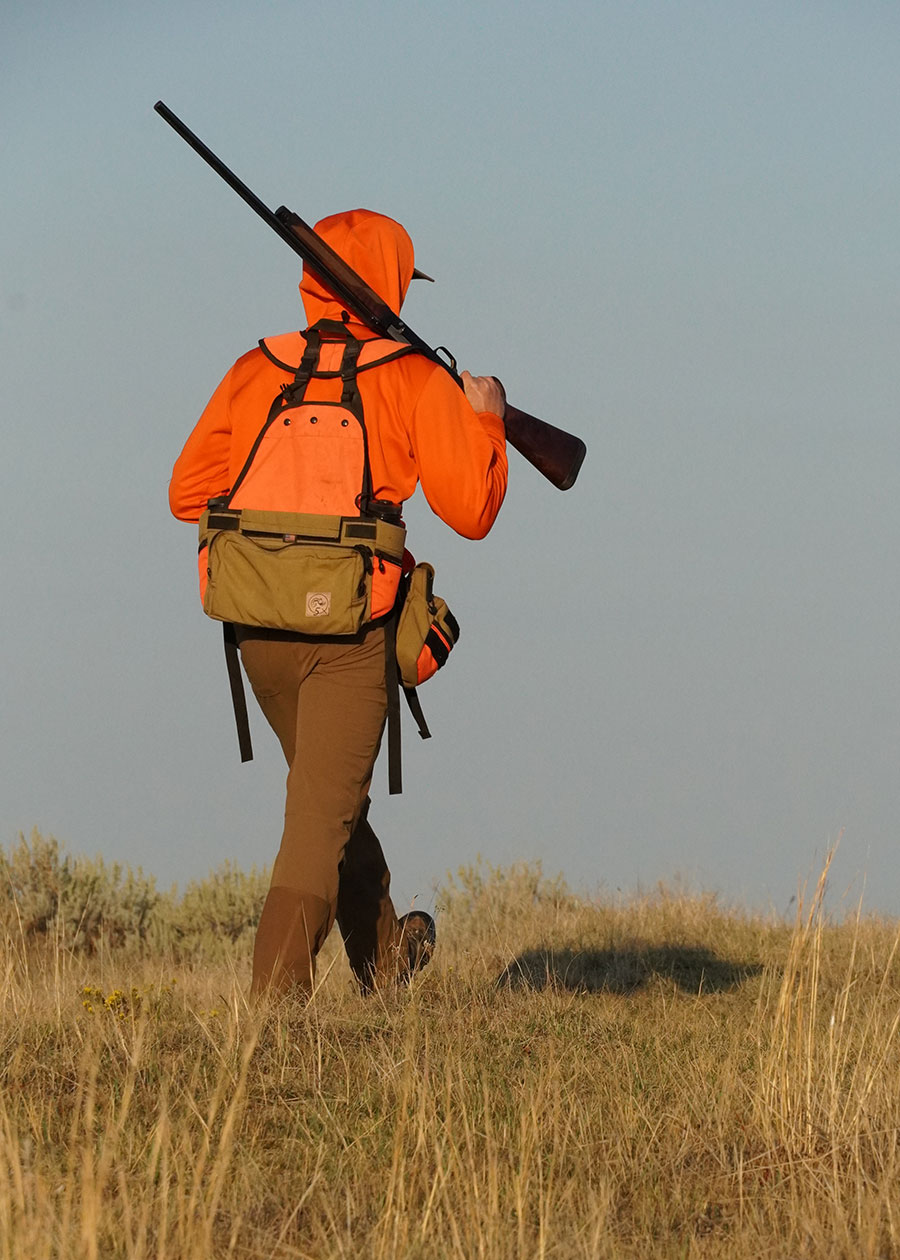 Hunter walking on prairie