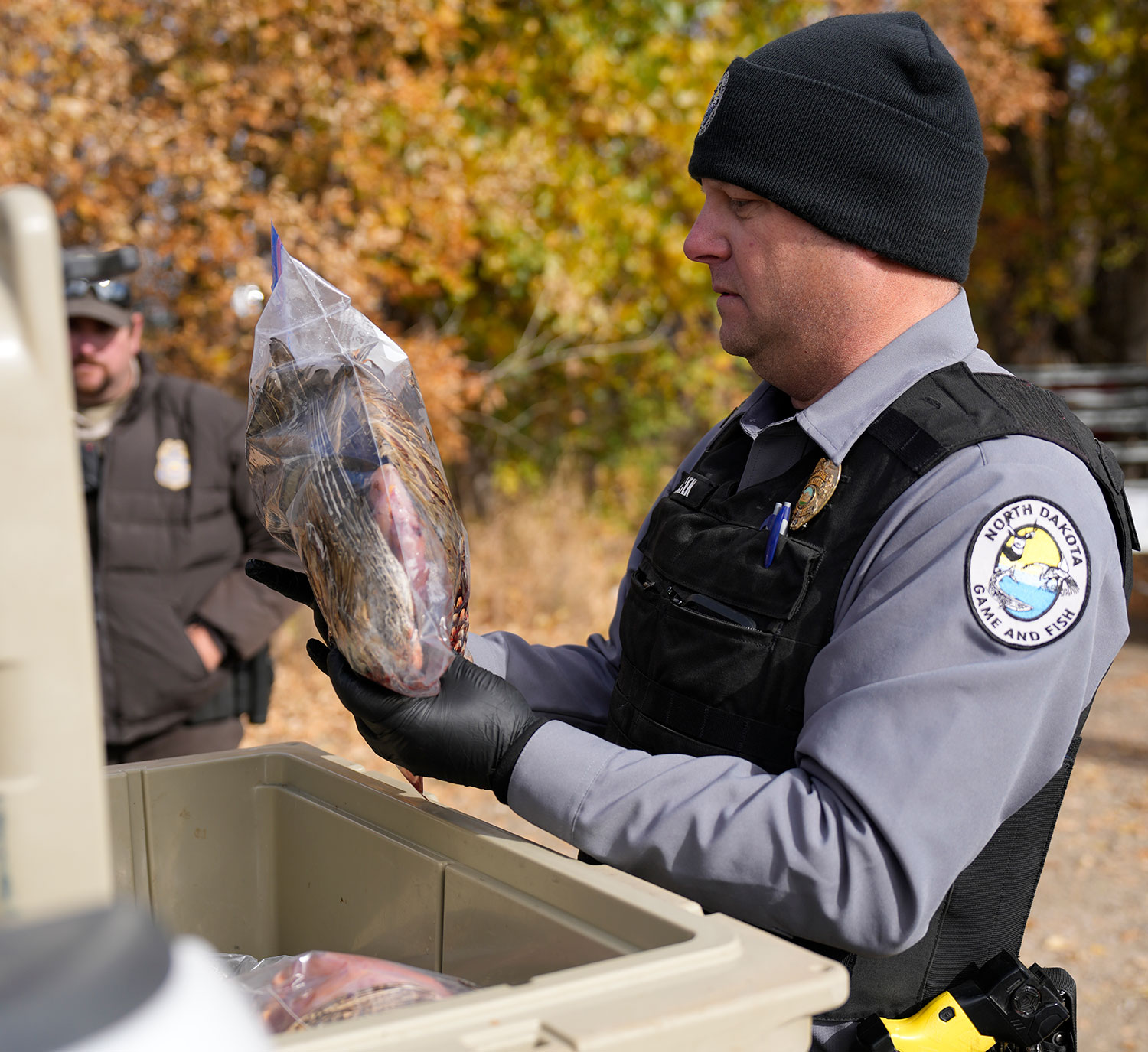 Game warden checking an hunter's harvest