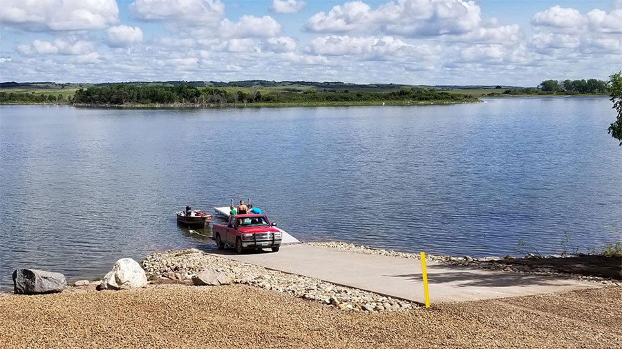 People launching a boat from a boat ramp