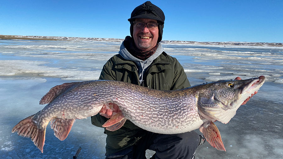 Angler holding large pike