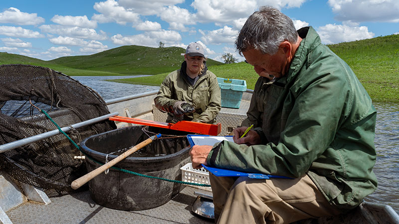 Biologists filling out crappie study paperwork while on boat