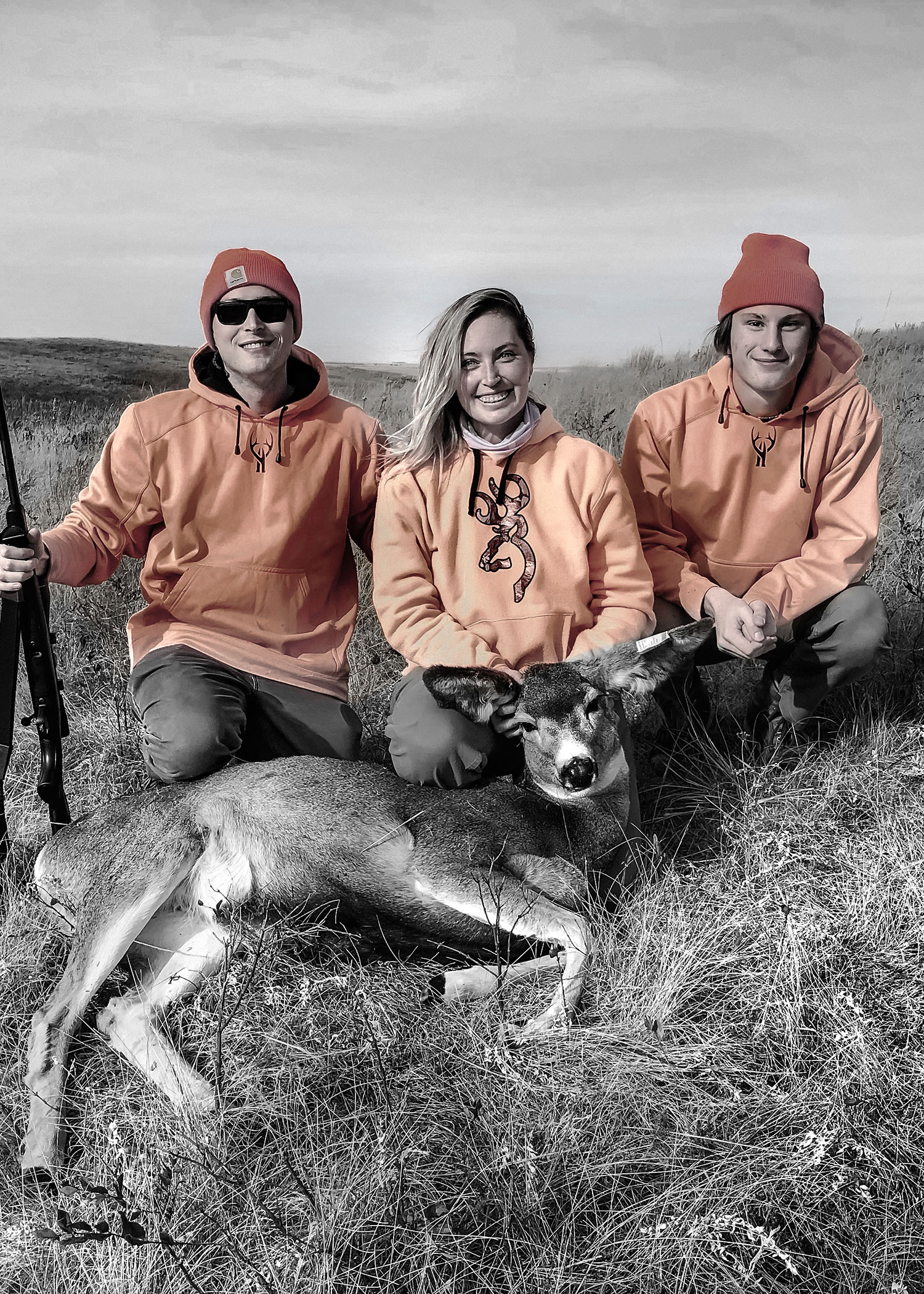 The Wilson boys, Nate (left) and Jack, pose with their sister, Lauren, and her first deer shot a handful of years ago.