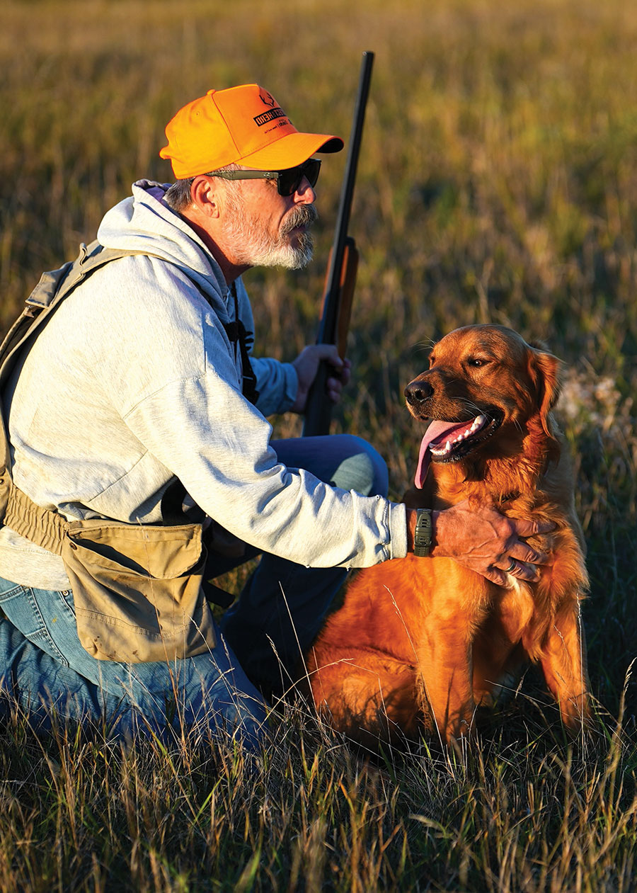 Ron Wilson with his dog in the field hunting for sharptails