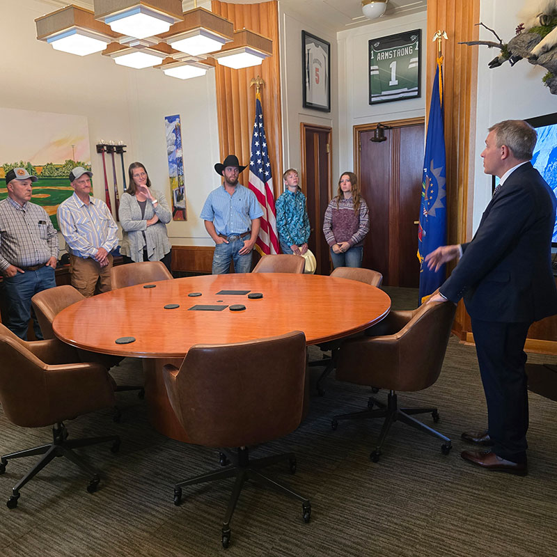 Governor and group of landowners in an office