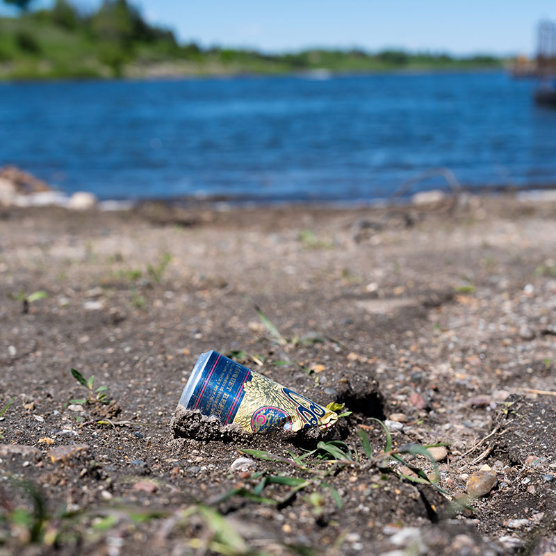 Littered can on a shore