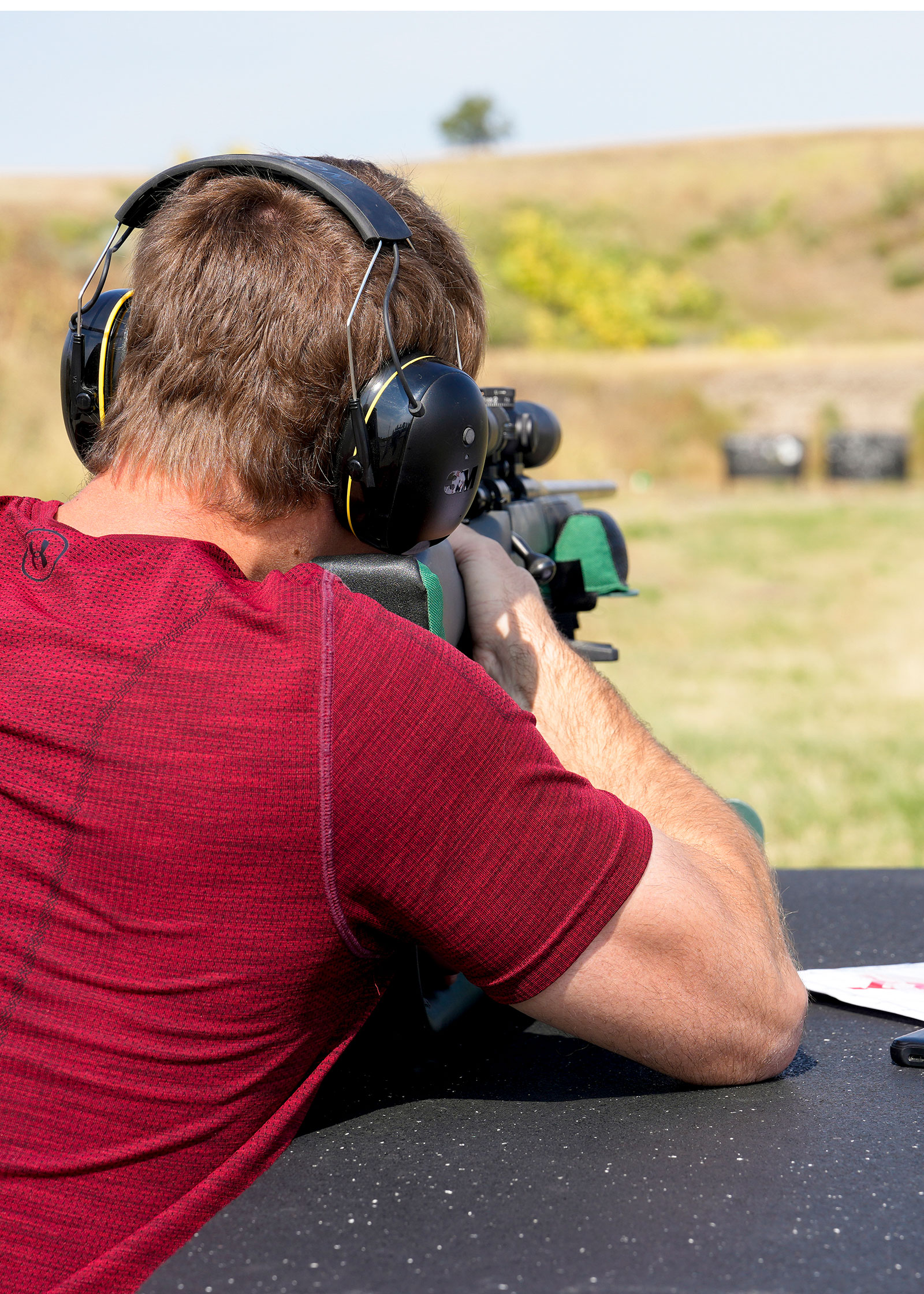 Person firing rifle at a shooting range