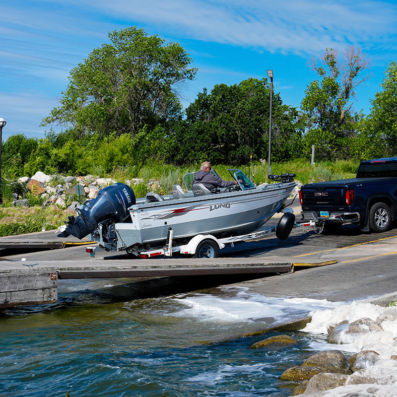 Person lanching boat at a ramp