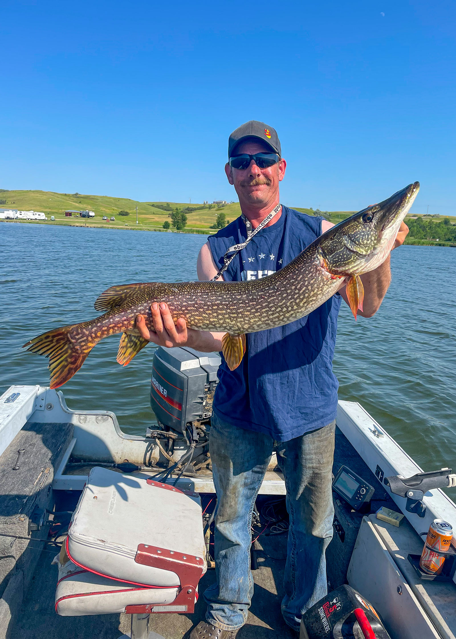 Angler on boat holding fish