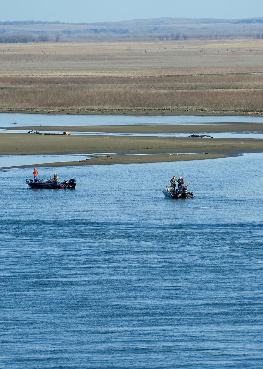 People fishing from boats on the water