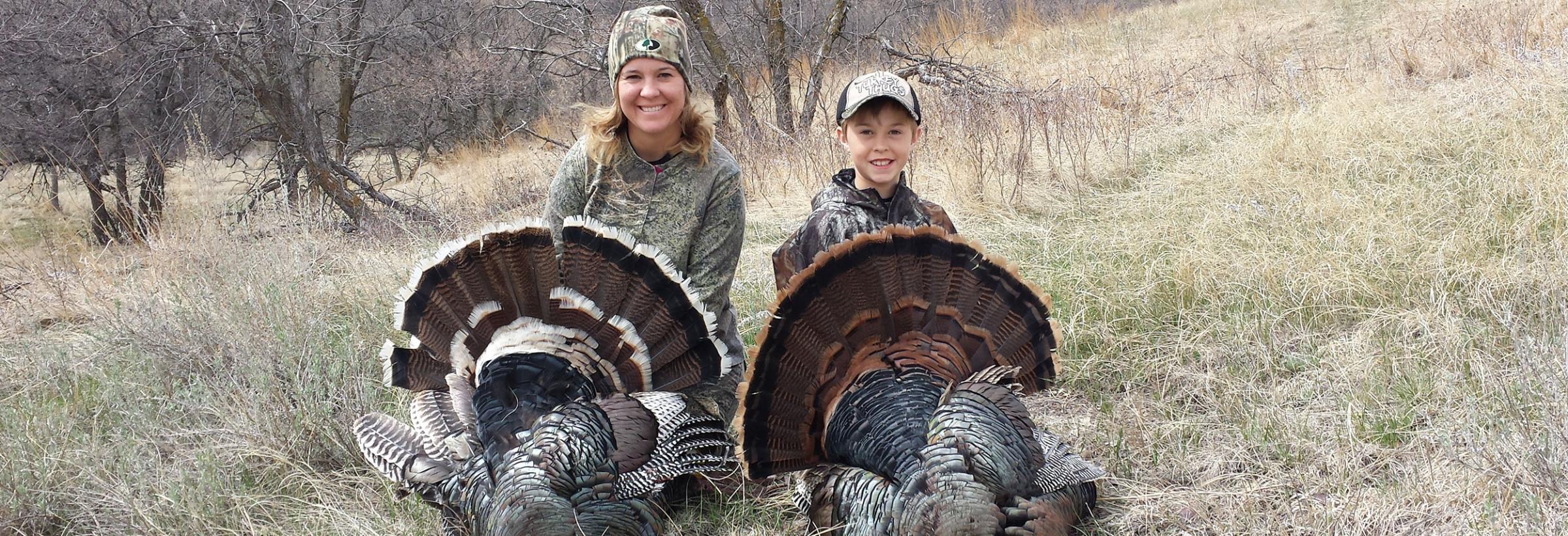 Mother and son with turkeys they harvested