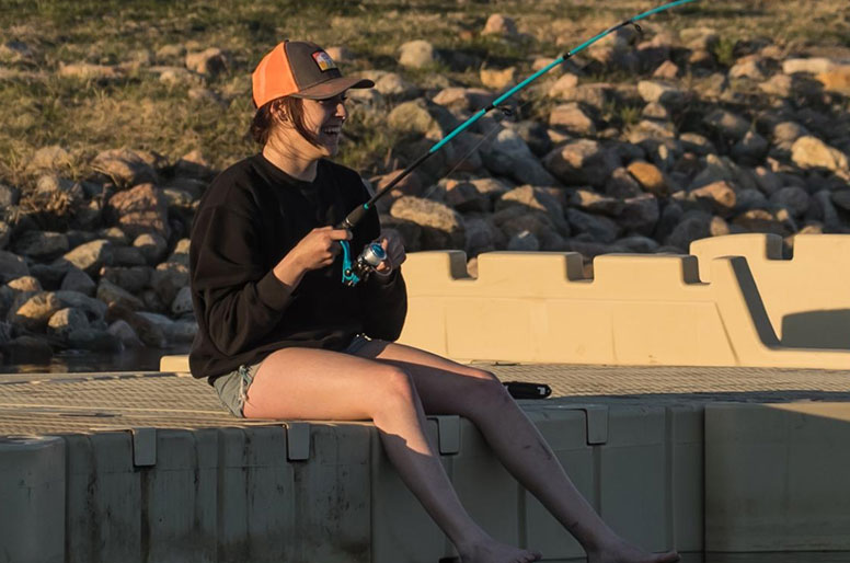 Woman fishing on dock