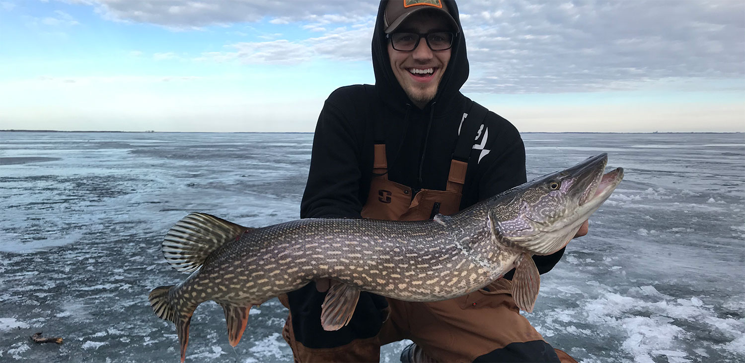 Angler holding pike