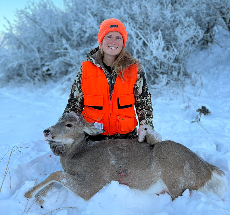 Cayla with harvested doe in snow