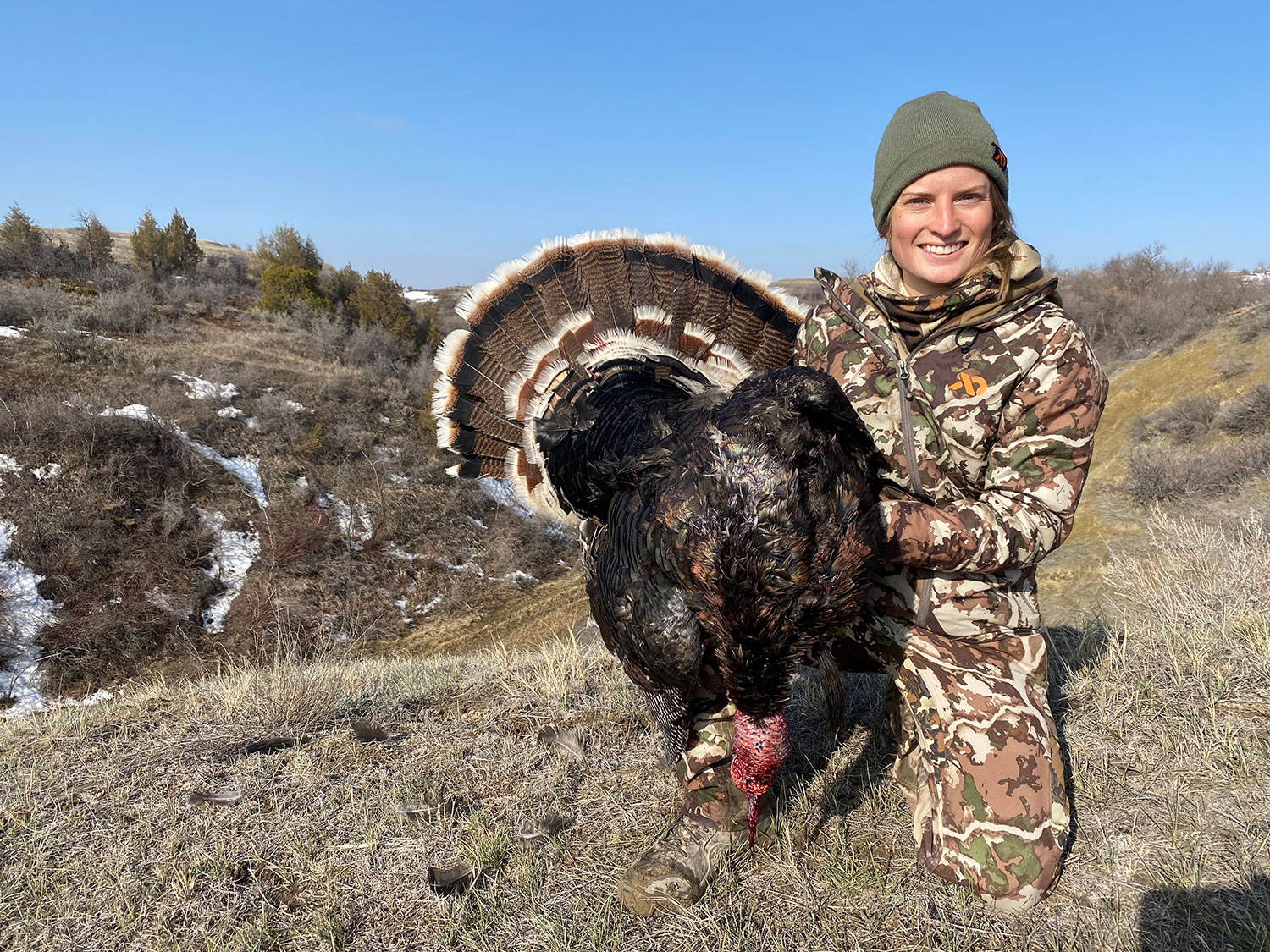 Cayla holding up turkey she harvested this spring