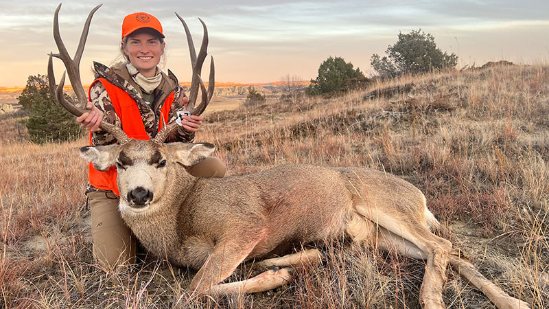 Cayla with her harvested mule deer buck