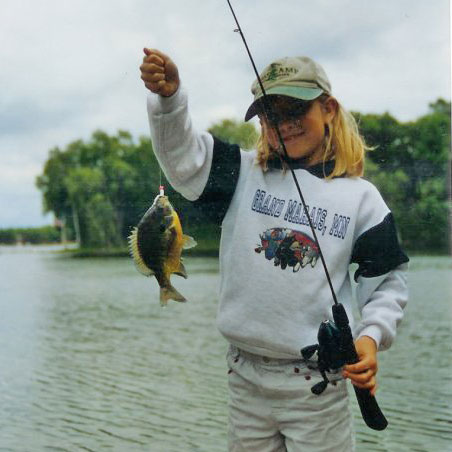 Cayla as a child with a fish she caught