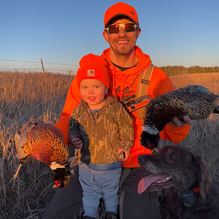 Finley with Fisher and Scott and harvested pheasants