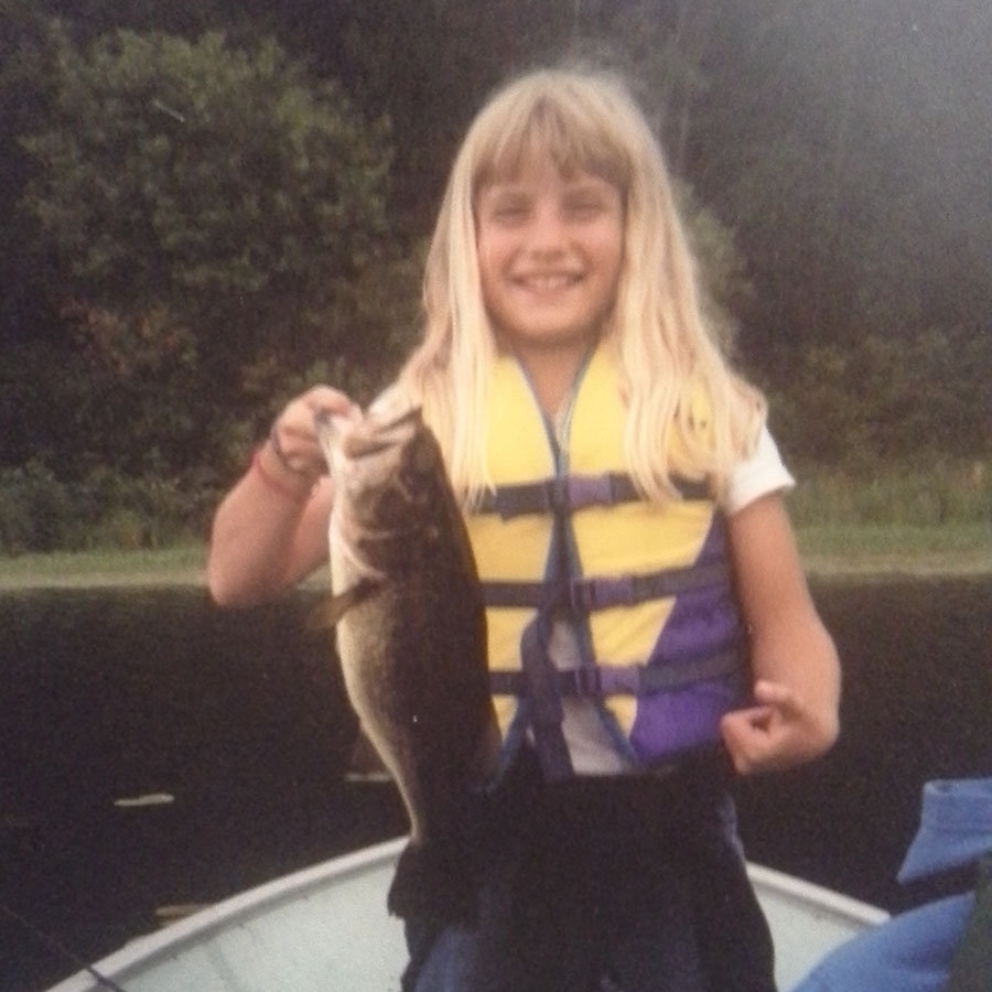 Cayla as a child holding a fish