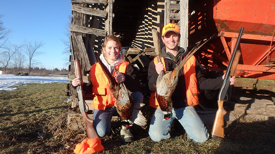 Cayla and brother with harvested pheasants